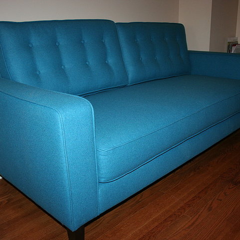 Title: The Enchanting Blue Sofa: A Masterpiece of Comfort and Style